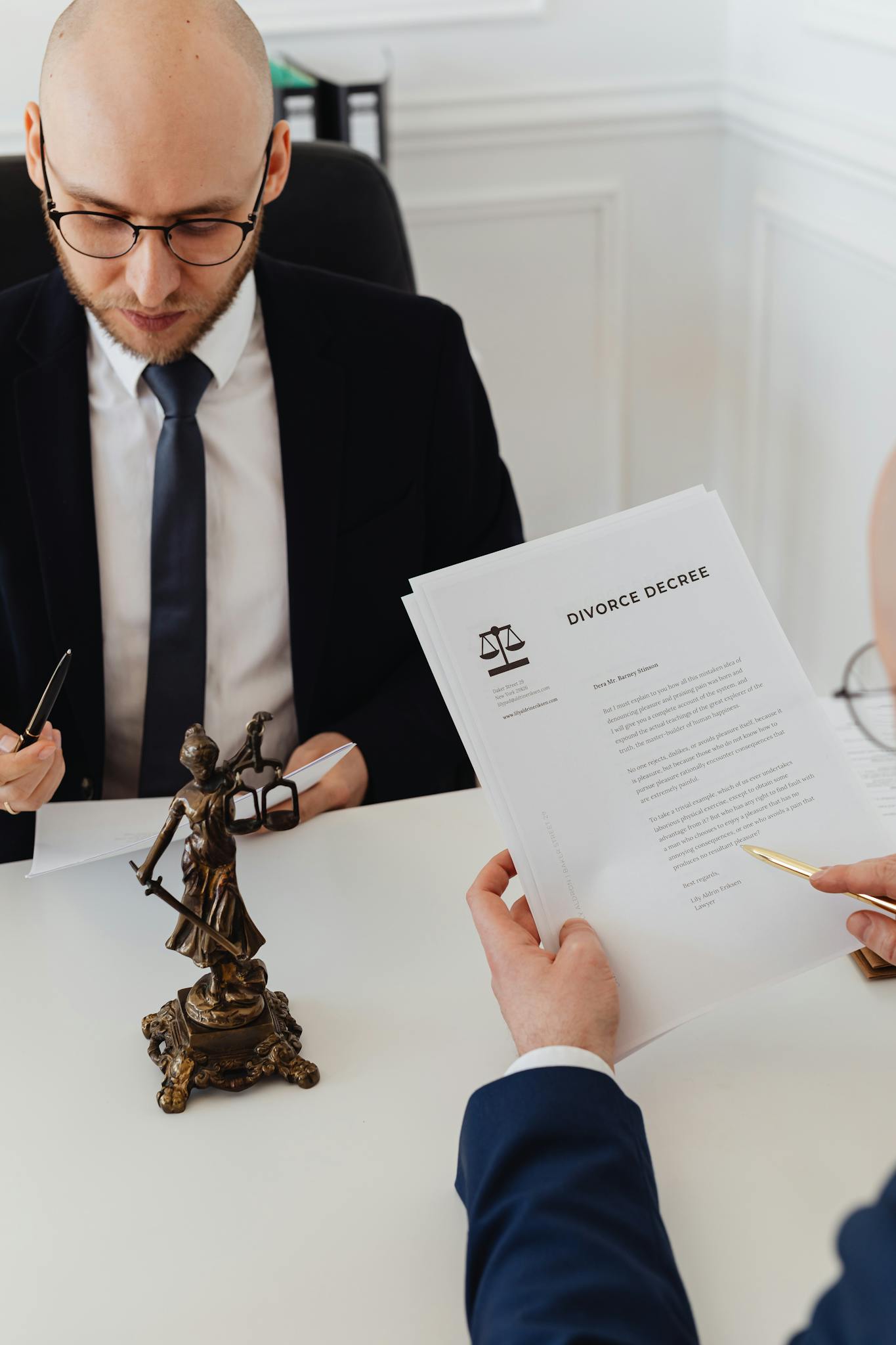 Two lawyers discussing divorce decree documents in a professional office setting.